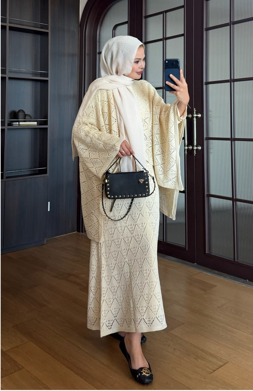 Cream openwork knit poncho and maxi skirt three piece set – front