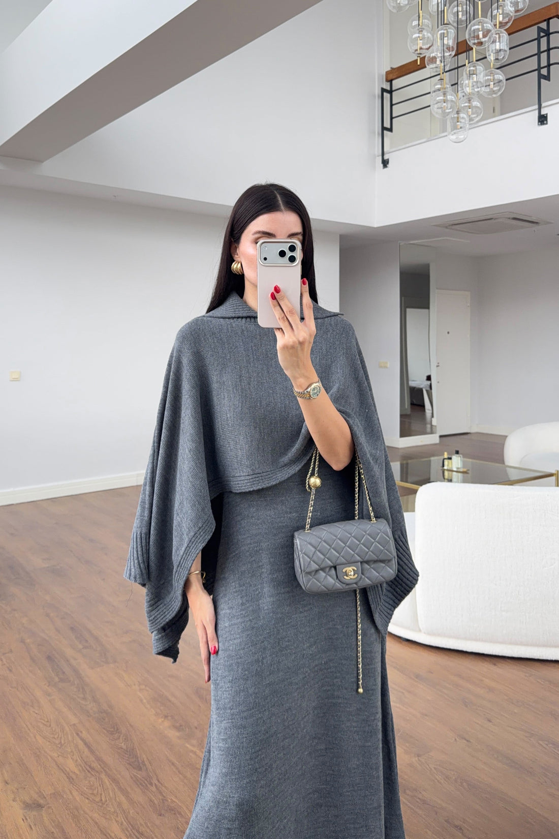 Charcoal sleeveless knitted dress and matching poncho on model