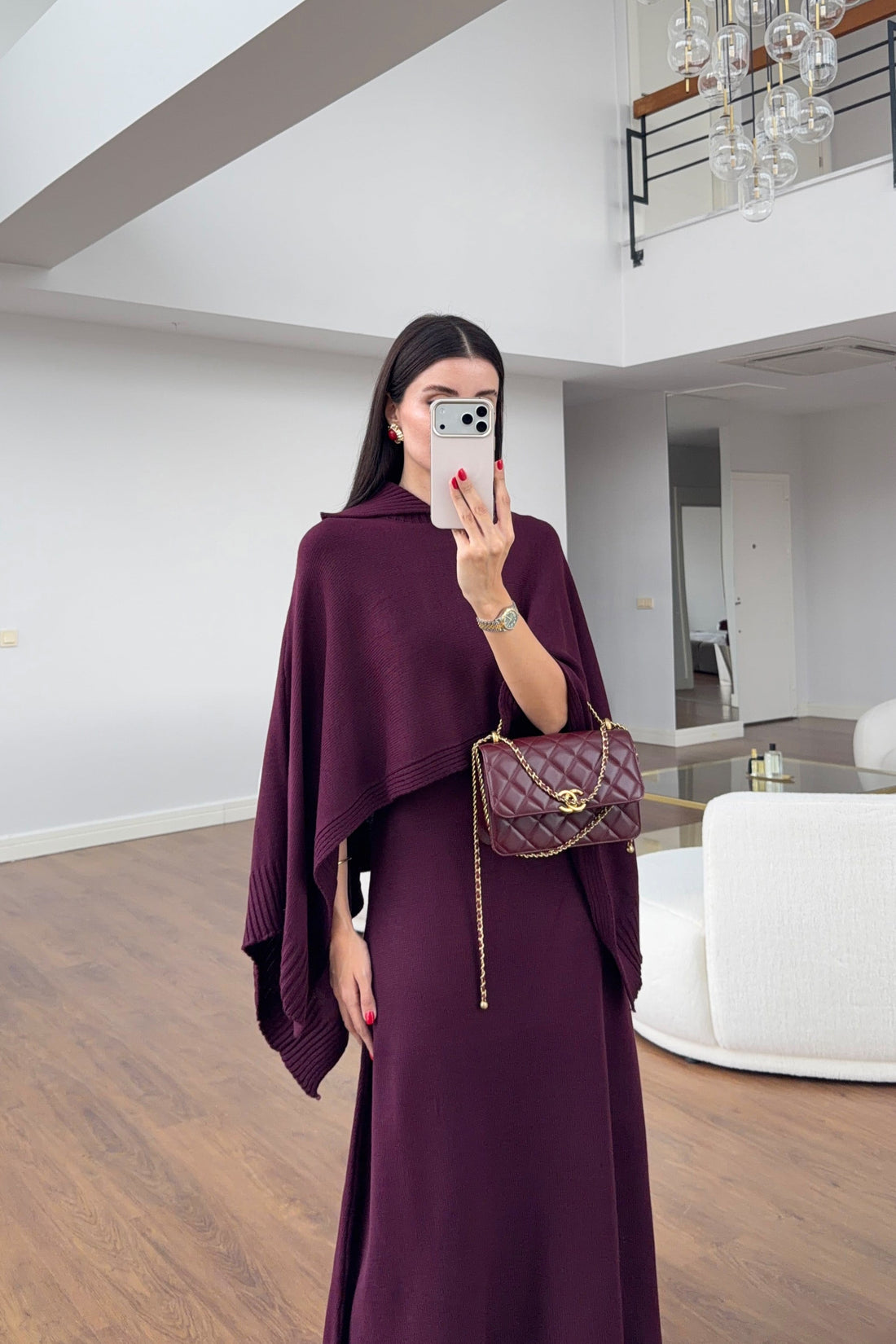Plum knit dress and poncho worn together, front detail