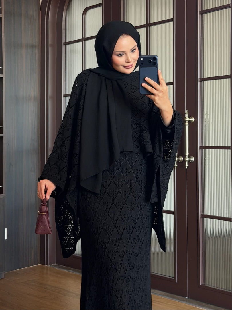 Black openwork knit poncho and maxi skirt three piece set – close