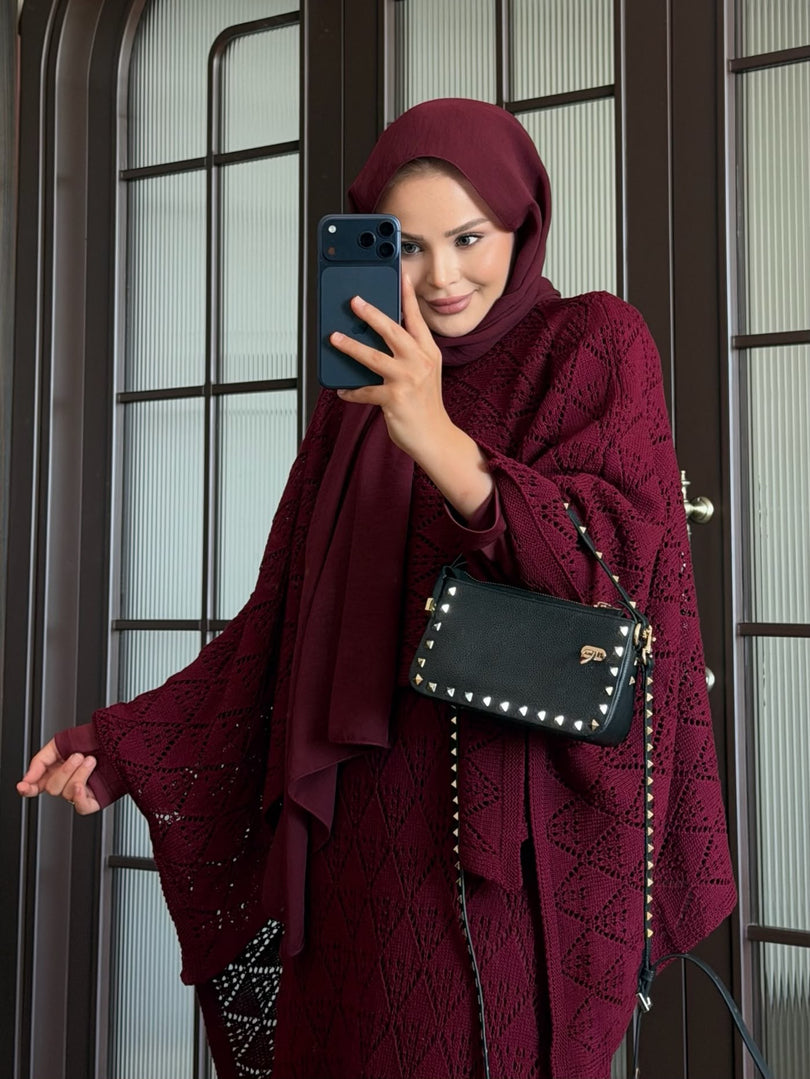 Burgundy openwork knit poncho and maxi skirt three piece set – close