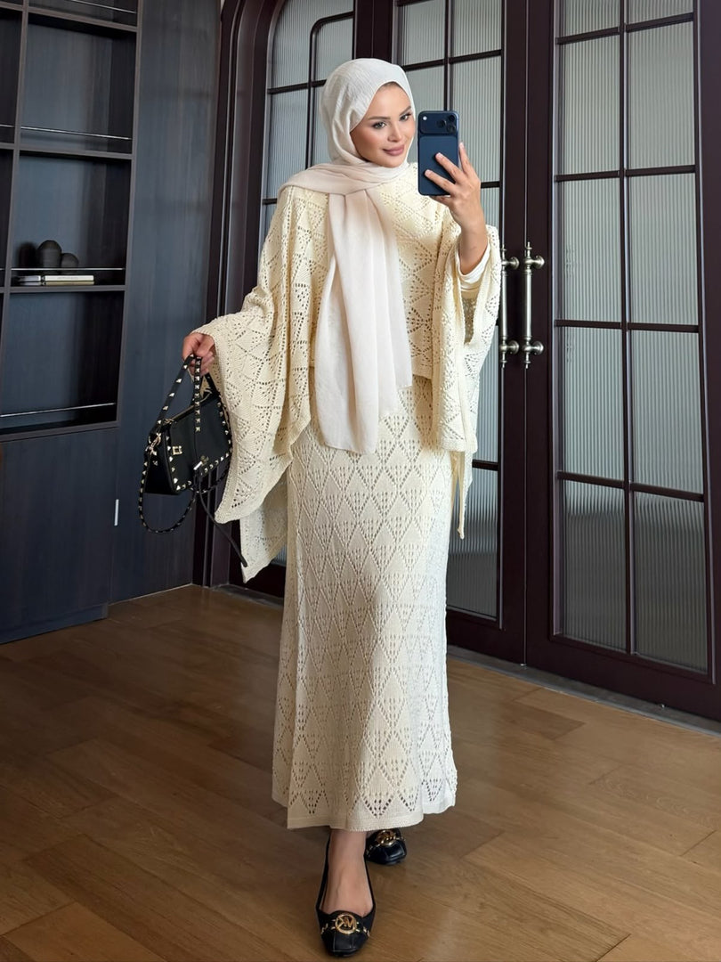 Cream openwork knit poncho and maxi skirt three piece set – standing
